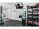 Home gym with mounted tv, mirrors, and extensive free weights setup at 310 Alamosa Pl, Cary, NC 27519