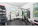Bright home gym featuring mirrors and a variety of fitness equipment at 310 Alamosa Pl, Cary, NC 27519
