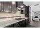 Gourmet kitchen featuring granite countertops, dark cabinets, and stainless steel appliances at 310 Alamosa Pl, Cary, NC 27519