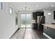 Eat-in kitchen features a stainless steel refrigerator, dark cabinets and sliding glass door at 310 Alamosa Pl, Cary, NC 27519