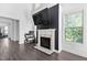 Cozy living room area with fireplace, large windows and recessed lighting at 310 Alamosa Pl, Cary, NC 27519