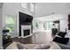 Open concept living space with fireplace, large windows and an open layout to the kitchen at 310 Alamosa Pl, Cary, NC 27519
