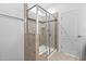 Glass-enclosed shower features neutral tile and built-in shelves at 310 Alamosa Pl, Cary, NC 27519