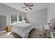 Bright bedroom featuring neutral walls, a ceiling fan, and large windows providing ample natural light at 3122 Jones Lake Rd, Fuquay Varina, NC 27526