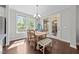 Bright and airy dining room featuring a wooden table with seating for six and natural light at 3122 Jones Lake Rd, Fuquay Varina, NC 27526