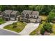 Aerial shot of the home's front exterior, driveway, well-manicured lawn, and neighborhood at 3122 Jones Lake Rd, Fuquay Varina, NC 27526