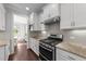 Modern kitchen featuring stainless steel appliances, ample counter space, and wood floors at 3122 Jones Lake Rd, Fuquay Varina, NC 27526