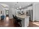 Bright, modern kitchen with white cabinets, granite countertops, and stainless steel appliances at 3122 Jones Lake Rd, Fuquay Varina, NC 27526