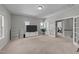 Spacious living room with neutral walls and a view to a workout room at 3122 Jones Lake Rd, Fuquay Varina, NC 27526
