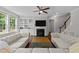 Cozy living room featuring a fireplace, built-in bookshelves, and comfortable seating at 3122 Jones Lake Rd, Fuquay Varina, NC 27526