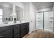 Modern bathroom with double vanity, dual mirrors, and a glass-enclosed shower at 314 N Coral Bells Way, Four Oaks, NC 27524