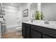 Modern bathroom featuring double vanity, framed mirror, tub, and shower combination at 314 N Coral Bells Way, Four Oaks, NC 27524