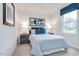 Cozy bedroom with blue and white decor, a comfortable bed, and a large window at 314 N Coral Bells Way, Four Oaks, NC 27524