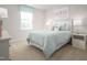 Bright bedroom with a comfortable bed, bedside tables and a large window at 314 N Coral Bells Way, Four Oaks, NC 27524