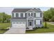 Charming two-story home with a garage, well-maintained lawn, and a welcoming front door at 314 N Coral Bells Way, Four Oaks, NC 27524