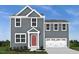 Charming two-story home with gray siding, a red front door, and an attached two-car garage at 314 N Coral Bells Way, Four Oaks, NC 27524