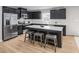 Modern kitchen with stainless steel appliances, island with seating, and sleek cabinets at 314 N Coral Bells Way, Four Oaks, NC 27524