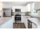 Modern kitchen featuring white cabinets, stainless steel appliances, and granite countertops at 314 N Coral Bells Way, Four Oaks, NC 27524