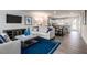 Open-concept living room with modern furniture and decor, connected to kitchen and dining area at 314 N Coral Bells Way, Four Oaks, NC 27524