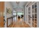 Inviting foyer with hardwood floors, shiplap walls, and stylish decor leading into the home at 316 Ibis Ln, Durham, NC 27703