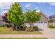 Charming brick home with well-maintained landscaping, lush trees, and a two-car garage at 316 Ibis Ln, Durham, NC 27703