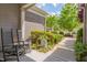 Cozy front porch with rocking chairs, green bushes and a walkway for a peaceful outdoor space at 316 Ibis Ln, Durham, NC 27703