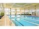 Bright indoor pool with marked lanes, seating areas, and large windows for a resort-like swimming experience at 316 Ibis Ln, Durham, NC 27703