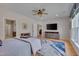 Spacious bedroom features a ceiling fan, television, and large windows for natural light at 316 Ibis Ln, Durham, NC 27703