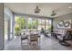 Bright sunroom featuring tile floors, comfortable seating, and scenic backyard views at 316 Ibis Ln, Durham, NC 27703