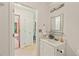 Well-lit bathroom featuring a vanity with a decorative mirror and a neutral color scheme at 3405 Bonaparte Way, Durham, NC 27707