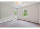 Empty bedroom featuring two large windows and neutral carpeting, providing a blank canvas at 3405 Bonaparte Way, Durham, NC 27707