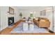 Bright living room featuring hardwood floors, a fireplace, and stylish contemporary furniture at 3405 Bonaparte Way, Durham, NC 27707