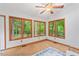 Tranquil sunroom bathed in natural light, featuring hardwood floors and backyard views at 3405 Bonaparte Way, Durham, NC 27707