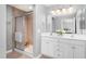Stylish bathroom with double vanity, shower with glass door, and tile flooring at 342 Faith Dr, Gibsonville, NC 27249