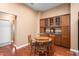 Cozy dining area features hardwood floors, classic wooden table and chairs, and built-in display cabinet at 342 Faith Dr, Gibsonville, NC 27249