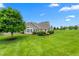 Beautiful home with a well-manicured lawn and lush landscaping on a sunny day at 342 Faith Dr, Gibsonville, NC 27249