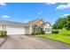 Home with a two-car garage, lush landscaping, and a manicured lawn on a beautiful day at 342 Faith Dr, Gibsonville, NC 27249