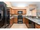 Well-equipped kitchen with granite countertops, wooden cabinets, and stainless steel appliances at 342 Faith Dr, Gibsonville, NC 27249