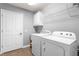 Clean laundry room featuring modern washer and dryer units, storage, and a utility sink at 342 Faith Dr, Gibsonville, NC 27249