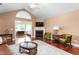 Open living room with hardwood floors, fireplace, and access to sunroom at 342 Faith Dr, Gibsonville, NC 27249