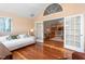 Open living room with hardwood floors and view of living room and kitchen through french doors at 342 Faith Dr, Gibsonville, NC 27249