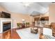 Cozy living room with fireplace, hardwood floors, and open layout to the kitchen at 342 Faith Dr, Gibsonville, NC 27249