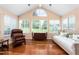 Bright sunroom with hardwood floors, large windows, and neutral decor at 342 Faith Dr, Gibsonville, NC 27249
