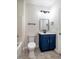 Bathroom with blue vanity, modern fixtures, and tiled flooring at 361 Anterbury Dr # B, Apex, NC 27502