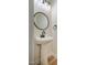 Half bath featuring a stylish pedestal sink, modern faucet, and decorative mirror at 361 Anterbury Dr # B, Apex, NC 27502