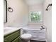 Bathroom featuring a soaking tub with tiled surround, and framed window at 361 Anterbury Dr # B, Apex, NC 27502