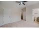 Bedroom with neutral walls, neutral carpet, ceiling fan, and two doors at 361 Anterbury Dr # B, Apex, NC 27502