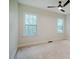 Bedroom featuring carpeted flooring, a ceiling fan, and two windows for natural light at 361 Anterbury Dr # B, Apex, NC 27502