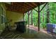 Covered patio features bare wood beams and an exterior exit to nature at 361 Anterbury Dr # B, Apex, NC 27502