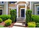Close up on front door of home with well kept bushes and green grass at 361 Anterbury Dr # B, Apex, NC 27502